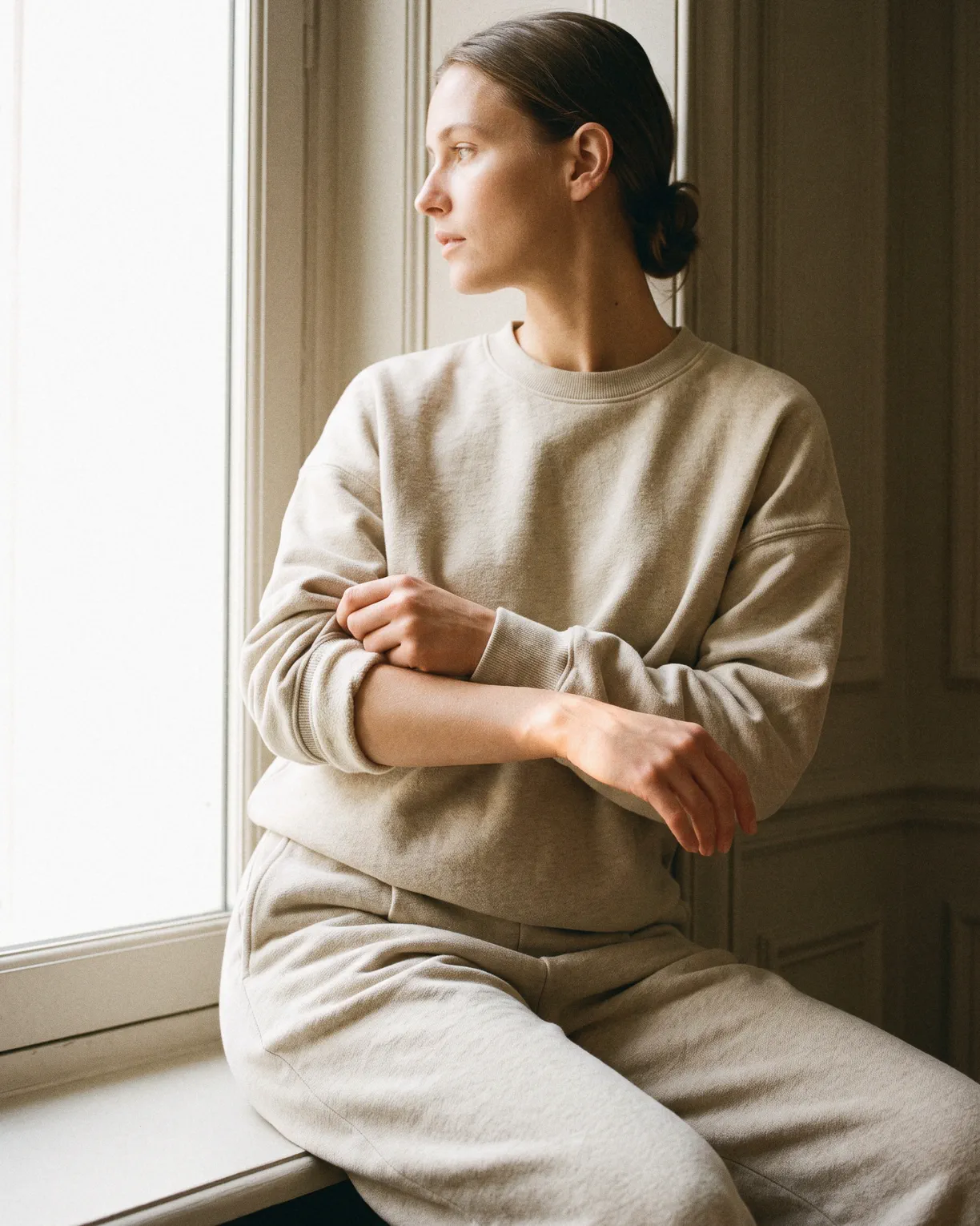 the after set, an oat brushed cotton crewneck and wide trousers, worn on a window ledge